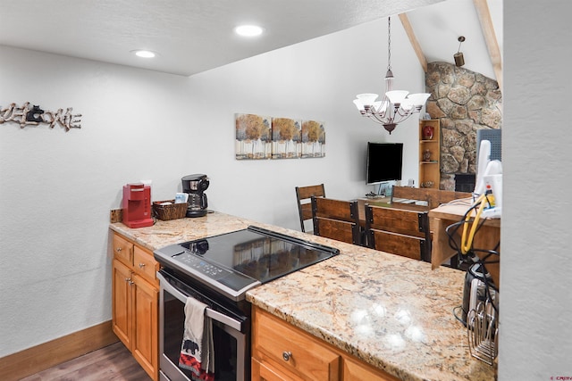 50827 N 550th Hwy Unit 329, Durango, CO 81301 - kitchen featuring stainless steel range with electric cooktop, wood finished floors, a chandelier, and light stone counters