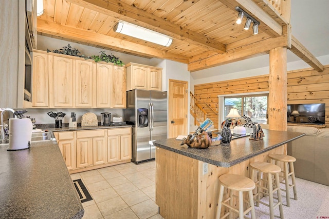 601 W Grimes Creek Rd, Bayfield, CO 81122 - kitchen with stainless steel refrigerator with ice dispenser, light brown cabinetry, dark countertops, a wood ceiling with exposed beams, and a kitchen bar
