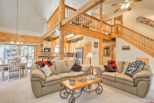601 W Grimes Creek Rd, Bayfield, CO 81122 - living area featuring high vaulted ceiling, a ceiling fan, light colored carpet, a chandelier, and stairway