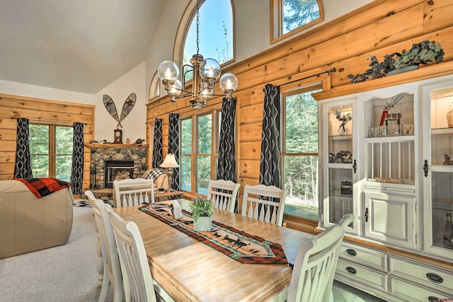 601 W Grimes Creek Rd, Bayfield, CO 81122 - carpeted dining space with high vaulted ceiling, plenty of natural light, a chandelier, and a stone fireplace