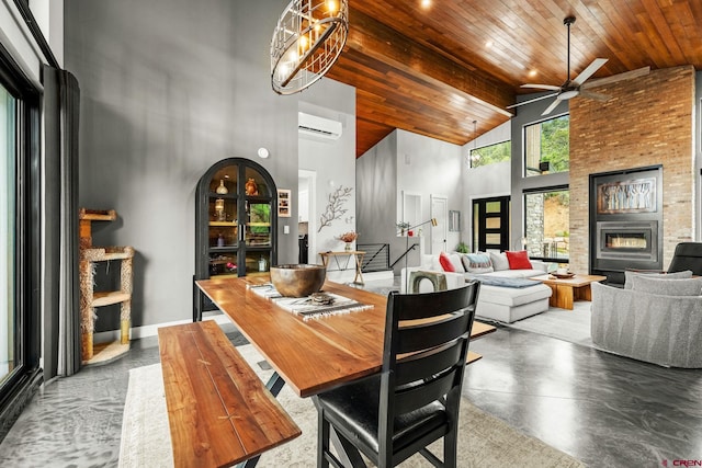 2161 Scout Ridge Rd, Durango, CO 81301 - dining space featuring high vaulted ceiling, a ceiling fan, a wall unit AC, a brick fireplace, and wood ceiling