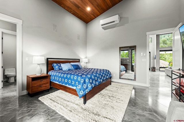 2161 Scout Ridge Rd, Durango, CO 81301 - bedroom with a wall mounted air conditioner, wooden ceiling, high vaulted ceiling, concrete floors, and ensuite bathroom