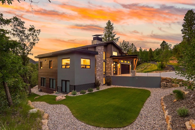 2161 Scout Ridge Rd, Durango, CO 81301 - back of property featuring a chimney, a yard, and stone siding