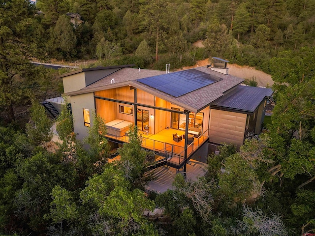 2161 Scout Ridge Rd, Durango, CO 81301 - back of house featuring a forest view, stairway, a shingled roof, and solar panels