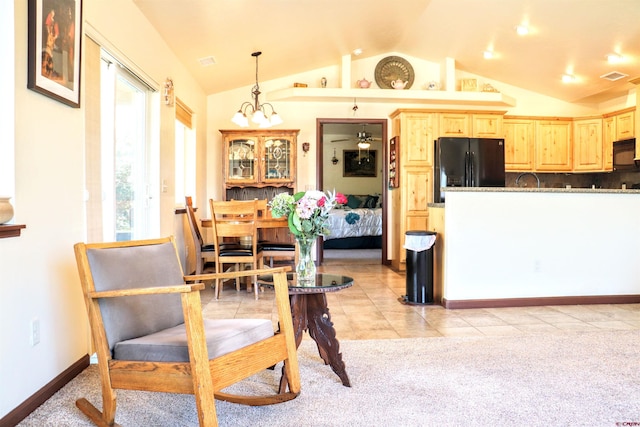 521 Alta Lakes Ave, Montrose, CO 81403 - kitchen with black appliances, light brown cabinetry, vaulted ceiling, light carpet, and light tile patterned flooring