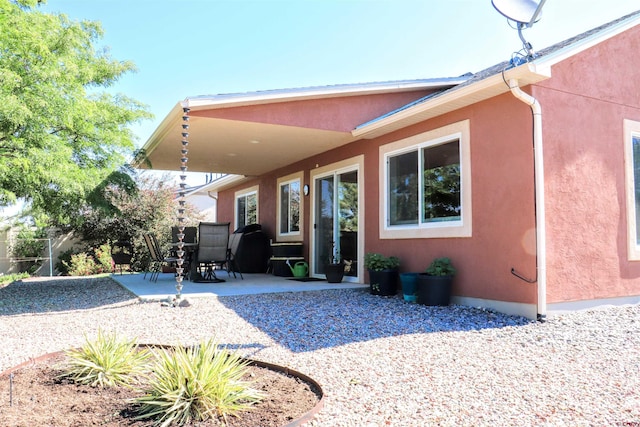 521 Alta Lakes Ave, Montrose, CO 81403 - back of property featuring a patio area and stucco siding