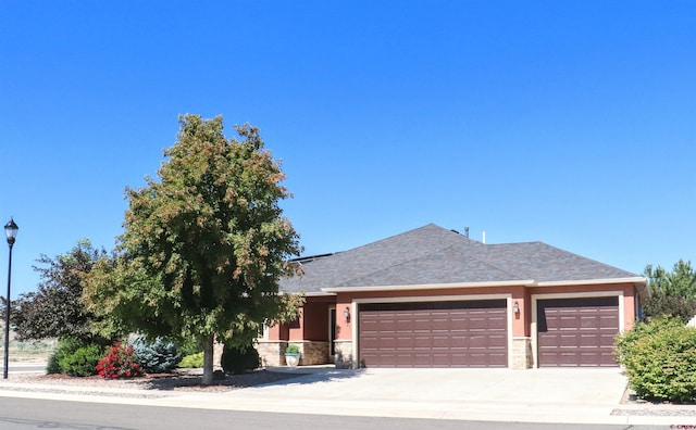 521 Alta Lakes Ave, Montrose, CO 81403 - view of front of property with a garage, stone siding, driveway, and a shingled roof