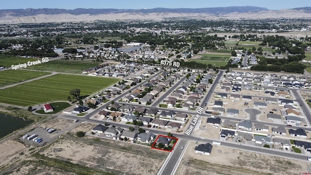 521 Alta Lakes Ave, Montrose, CO 81403 - aerial overview of property's location featuring property parcel outlined, a water and mountain view, and nearby suburban area