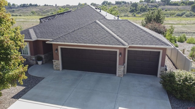 521 Alta Lakes Ave, Montrose, CO 81403 - ranch-style house with stone siding, an attached garage, concrete driveway, and stucco siding