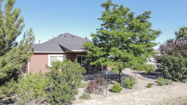 521 Alta Lakes Ave, Montrose, CO 81403 - back of house featuring stucco siding, a patio area, and roof with shingles