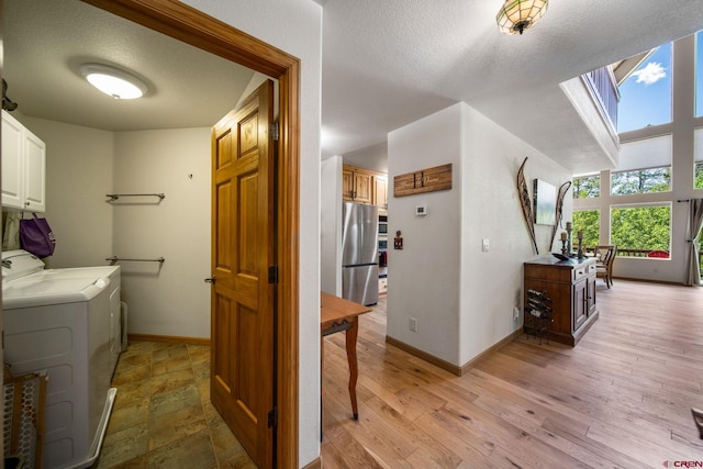 261 Aspen Dr, Durango, CO 81301 - laundry area featuring cabinet space, washer and clothes dryer, a textured ceiling, and a skylight