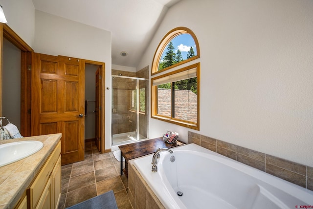 261 Aspen Dr, Durango, CO 81301 - full bathroom featuring a stall shower, a bath, lofted ceiling, and vanity