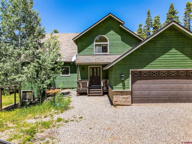 261 Aspen Dr, Durango, CO 81301 - view of front of home with french doors, an attached garage, roof with shingles, a porch, and stone siding