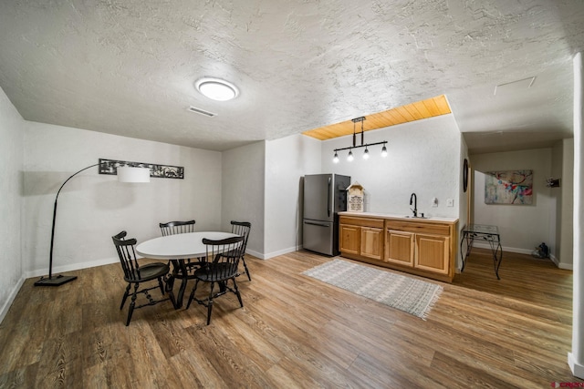 261 Aspen Dr, Durango, CO 81301 - dining space featuring light wood-type flooring and a textured ceiling