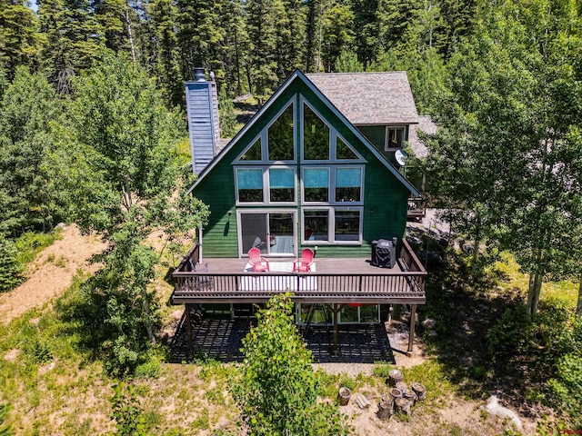 261 Aspen Dr, Durango, CO 81301 - rear view of house with a deck, a view of trees, and a chimney