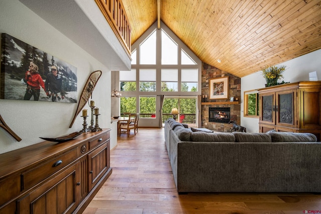 261 Aspen Dr, Durango, CO 81301 - living room featuring high vaulted ceiling, healthy amount of natural light, a stone fireplace, light wood-style floors, and wooden ceiling