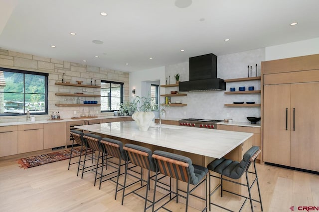 33 Aperture Ln, Crested Butte, CO 81224 - kitchen with open shelves, wall chimney exhaust hood, light wood-style flooring, tasteful backsplash, and recessed lighting