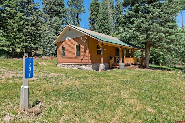 17401 County Road 501, Bayfield, CO 81122 - view of property exterior with a porch, a lawn, and a metal roof