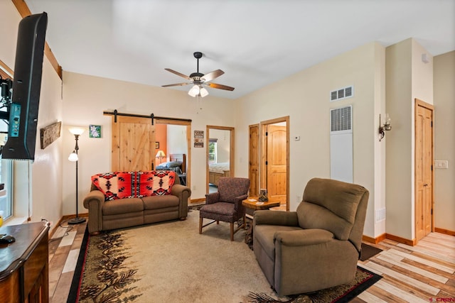 17401 County Road 501, Bayfield, CO 81122 - living room with a barn door, ceiling fan, and light wood-style floors