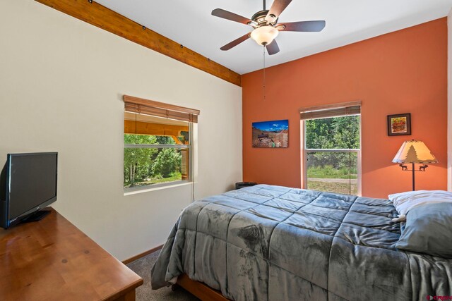 17401 County Road 501, Bayfield, CO 81122 - carpeted bedroom with multiple windows, beamed ceiling, and ceiling fan