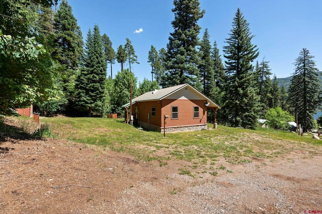 17401 County Road 501, Bayfield, CO 81122 - view of side of property with a lawn and a wooded view