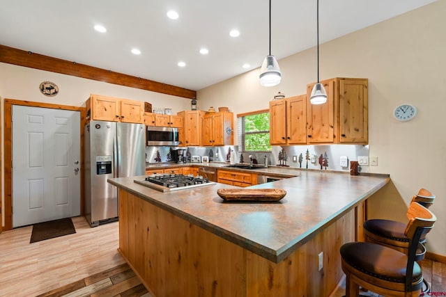 17401 County Road 501, Bayfield, CO 81122 - kitchen with stainless steel appliances, a peninsula, recessed lighting, a breakfast bar area, and light wood finished floors