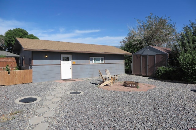 20657 Del Ray Dr, Eckert, CO 81418 - view of front of house featuring an outdoor fire pit, a storage unit, and a patio