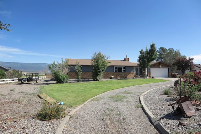 20657 Del Ray Dr, Eckert, CO 81418 - ranch-style home with an attached garage, brick siding, driveway, and a chimney