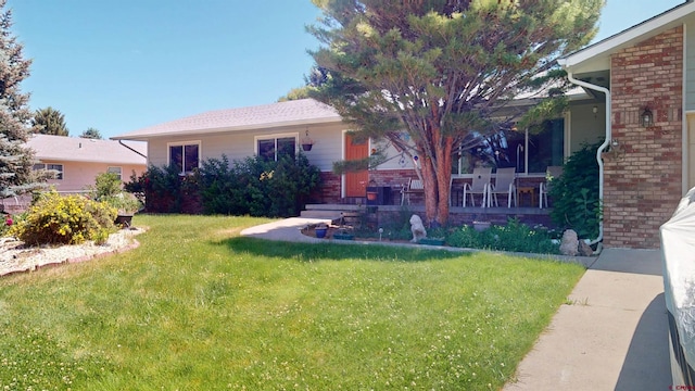 100 Paonia Ave, Paonia, CO 81428 - view of front facade with brick siding and a front lawn