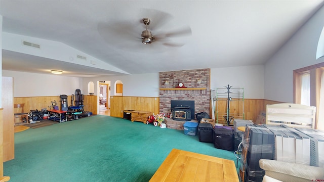 100 Paonia Ave, Paonia, CO 81428 - living room with wainscoting, wooden walls, ceiling fan, vaulted ceiling, and carpet