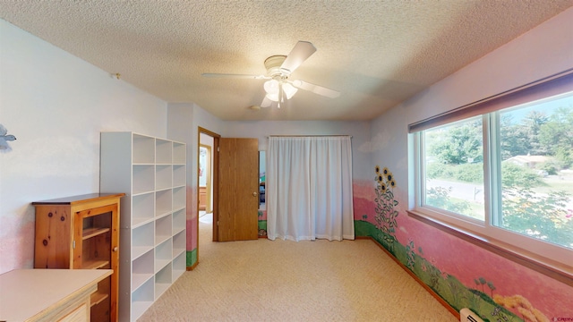 100 Paonia Ave, Paonia, CO 81428 - bedroom featuring light carpet, a textured ceiling, and a ceiling fan