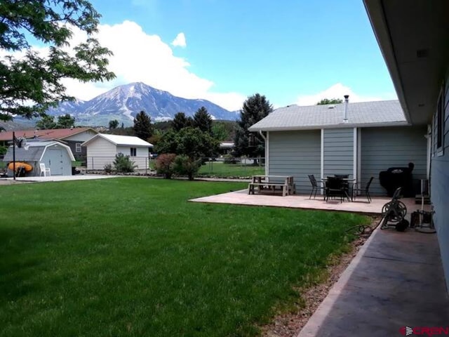 100 Paonia Ave, Paonia, CO 81428 - view of yard featuring a mountain view and a patio area