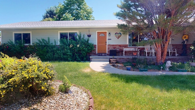 100 Paonia Ave, Paonia, CO 81428 - view of front facade featuring brick siding, a front lawn, and a porch