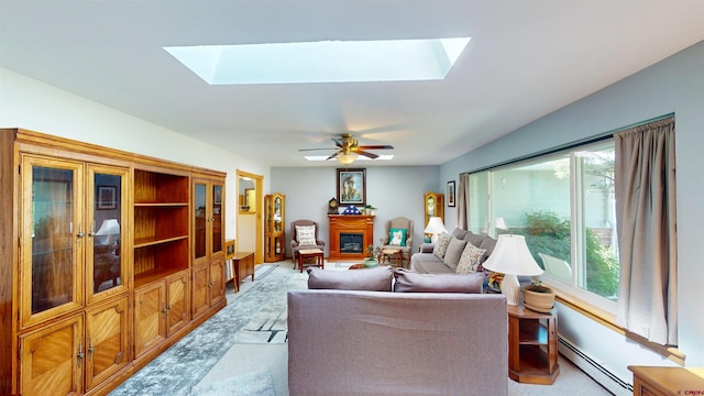 100 Paonia Ave, Paonia, CO 81428 - living area featuring a skylight, a baseboard heating unit, a glass covered fireplace, and ceiling fan