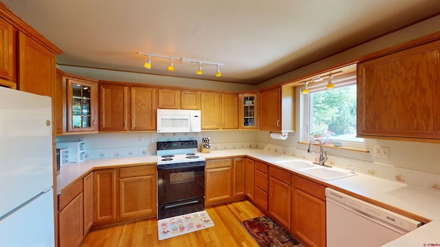 100 Paonia Ave, Paonia, CO 81428 - kitchen with white appliances, light wood-style flooring, glass insert cabinets, light countertops, and brown cabinetry