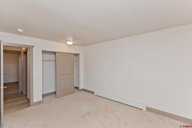 109 Anna Ct Unit 8B, Grand Junction, CO 81503 - unfurnished bedroom with a baseboard heating unit, light carpet, and a closet