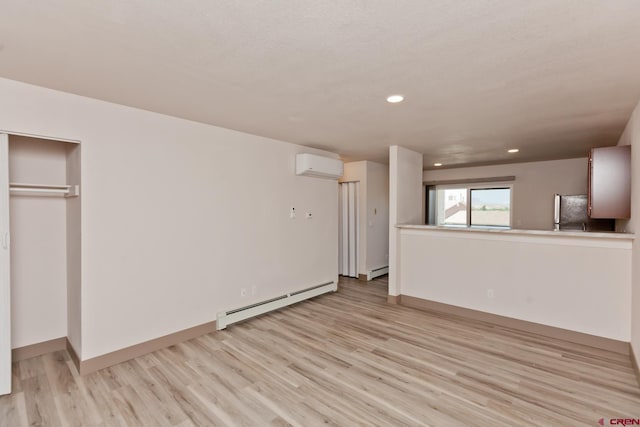 109 Anna Ct Unit 8B, Grand Junction, CO 81503 - unfurnished living room with a baseboard heating unit, a wall mounted air conditioner, light wood-style flooring, and recessed lighting