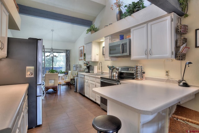 2920 Holly Ave Unit 104, Durango, CO 81301 - kitchen featuring stainless steel appliances, light countertops, white cabinetry, and a breakfast bar area