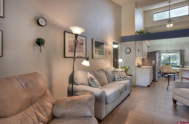 2920 Holly Ave Unit 104, Durango, CO 81301 - living room with plenty of natural light, a towering ceiling, and light wood-style floors