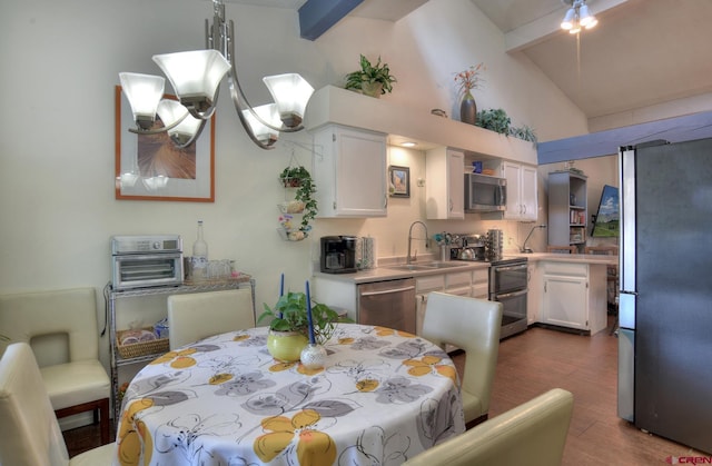 2920 Holly Ave Unit 104, Durango, CO 81301 - dining area with dark wood finished floors, beam ceiling, and high vaulted ceiling