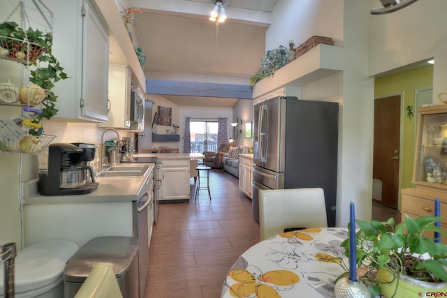 2920 Holly Ave Unit 104, Durango, CO 81301 - kitchen with stainless steel refrigerator with ice dispenser, beam ceiling, open floor plan, white cabinetry, and high vaulted ceiling