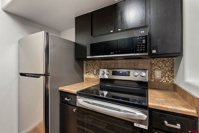 1100 Goeglein Gulch Rd Unit 171, Durango, CO 81301 - kitchen featuring appliances with stainless steel finishes, dark cabinets, backsplash, and light countertops