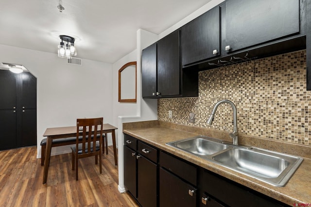 1100 Goeglein Gulch Rd Unit 171, Durango, CO 81301 - kitchen with backsplash, wood finished floors, and dark cabinets