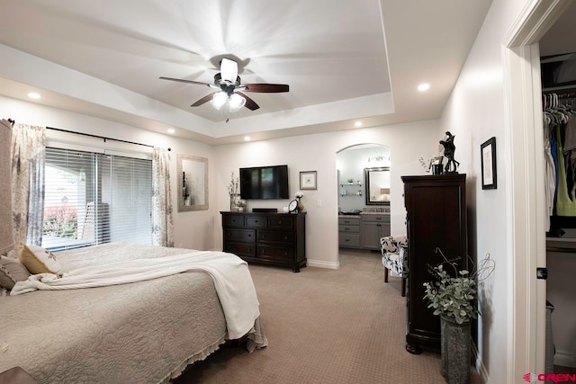 1734 Dry Creek Cir, Delta, CO 81416 - bedroom with light carpet, a raised ceiling, recessed lighting, arched walkways, and a ceiling fan
