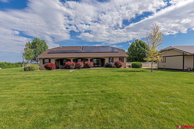 1734 Dry Creek Cir, Delta, CO 81416 - back of house with roof mounted solar panels and a lawn