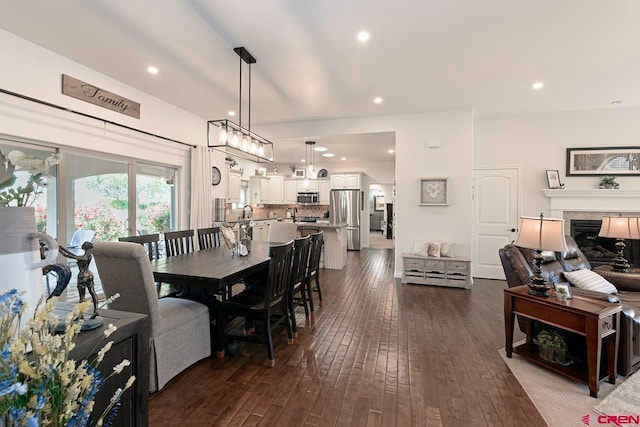 1734 Dry Creek Cir, Delta, CO 81416 - dining space with dark wood-style flooring, a fireplace, and recessed lighting