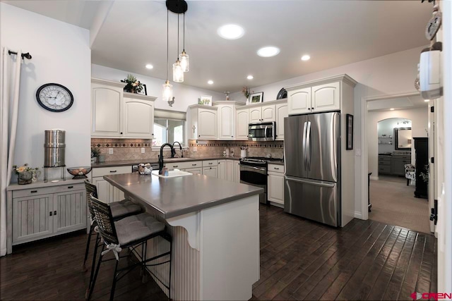 1734 Dry Creek Cir, Delta, CO 81416 - kitchen with appliances with stainless steel finishes, dark wood finished floors, decorative backsplash, hanging light fixtures, and recessed lighting