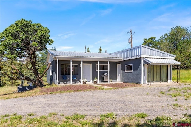 21932 2225th Rd, Cedaredge, CO 81413 - back of property featuring a metal roof, a porch, and dirt driveway