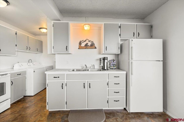 21932 2225th Rd, Cedaredge, CO 81413 - kitchen featuring white appliances, washing machine and clothes dryer, light countertops, gray cabinets, and a textured ceiling