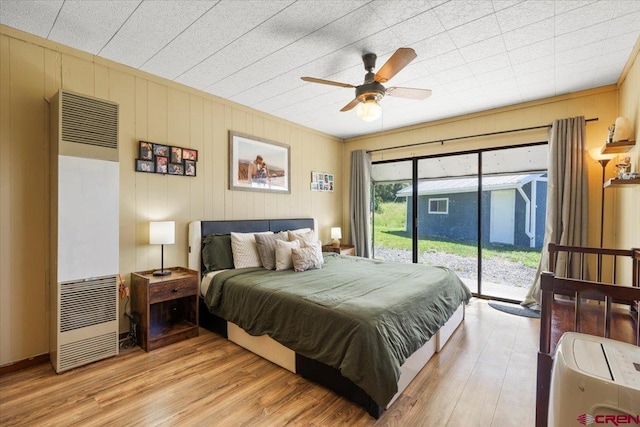 21932 2225th Rd, Cedaredge, CO 81413 - bedroom featuring a heating unit, access to exterior, light wood finished floors, and a ceiling fan